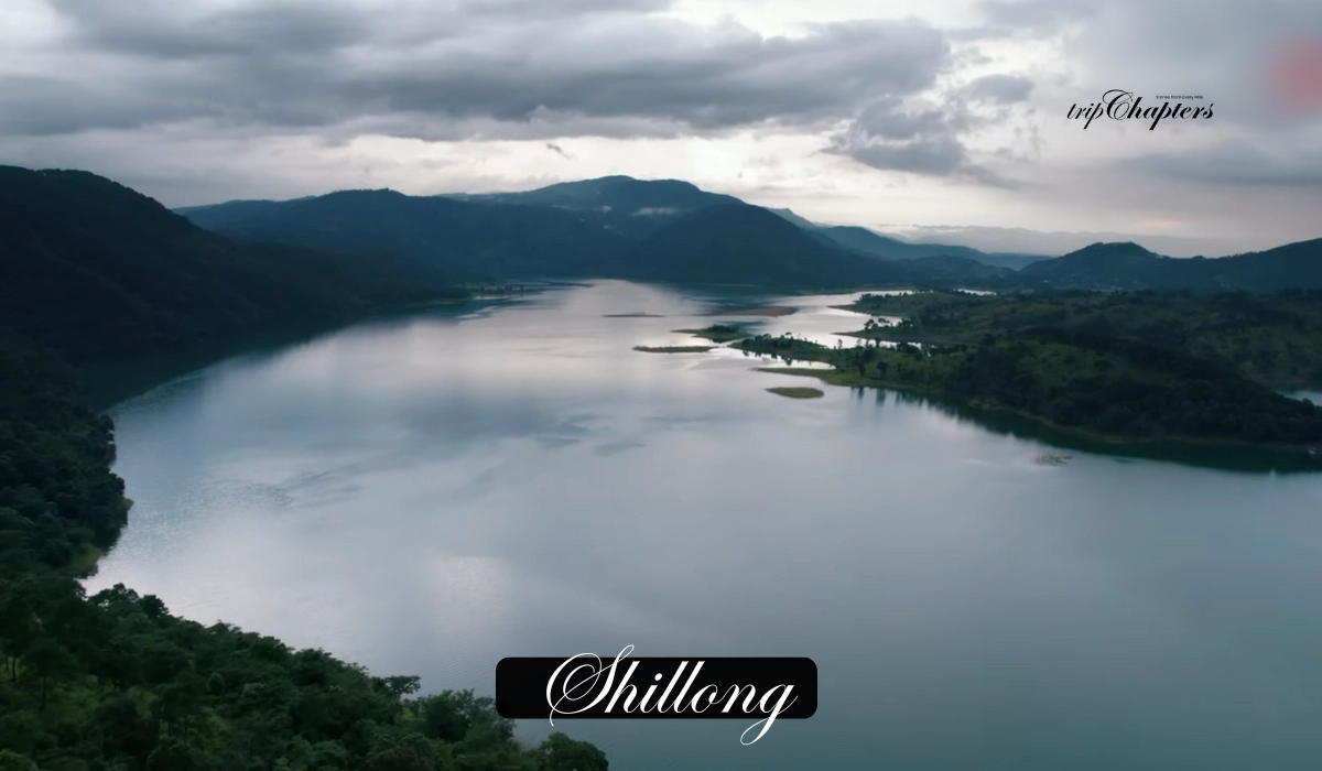 Aerial view of a serene lake surrounded by mountains in Shillong'